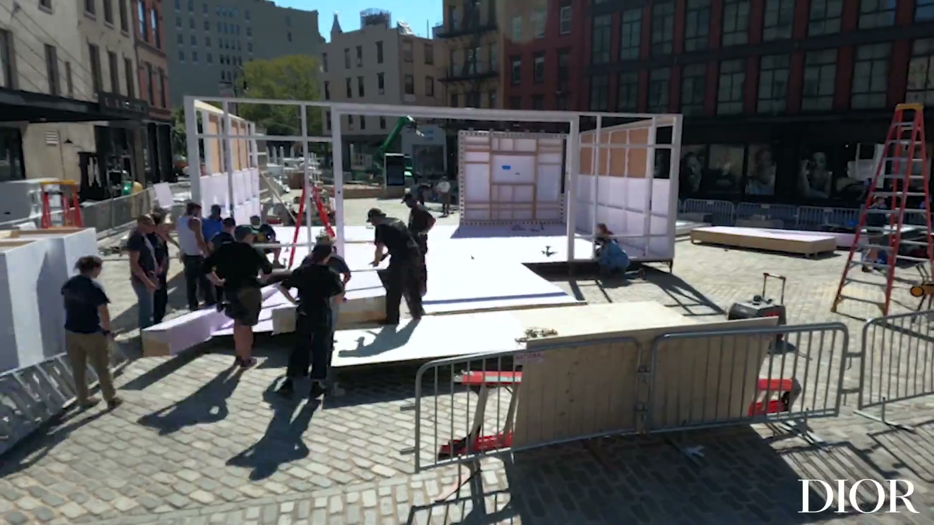 Crew assembling the Miss Dior Millefiori pop-up structure on Gansevoort Plaza